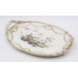A 19th century porcelain tray, of twin handled oval form, the centre decorated with birds amidst