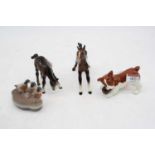 A Beswick model of a dog, h.6.5cm; together with a Beswick model of three mallard ducks, and two