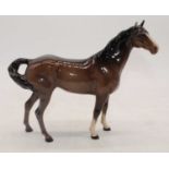 A Beswick model of a swish-tail horse, model No.1182, brown gloss, h.21cm