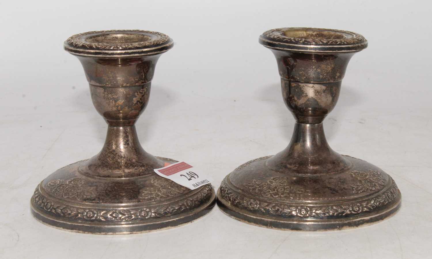 A pair of Fisher sterling silver rose bouquet pattern weighted dwarf table candlesticks, height 9cm