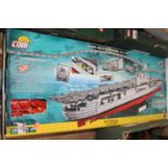 A Cobi USS Enterprise plastic brick building kit together with a Cobi RMS Titanic plastic brick