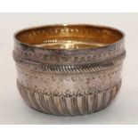 A Victorian silver sugar bowl of half gadrooned form, having gilt washed interior, London 1882, 5.