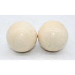 A pair of early 20th century turned ivory billiard ballsEach approx. 116g and 4.5cm across.