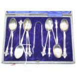 A set of six George V silver apostle spoons with sugar tongs in fitted case, together with one other