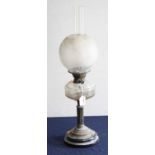 A late Victorian oil lamp, having opalescent globular shade above a clear glass font, on a fluted