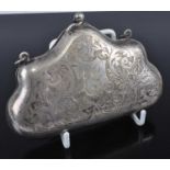 A white metal lady's evening purse, the obverse with leaf and flower engraving and monogrammed