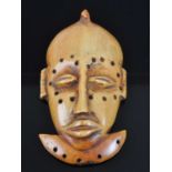 An early 20th century African carved ivory passport mask/pendant, carved as an elongated male face
