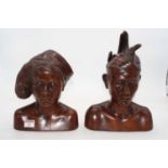 A pair of 20th century North African carved male and female head and shoulders portrait busts,