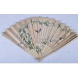 A Japanese Meiji period (1868-1912) ladies fan, having ivory sticks with a silk canopy hand