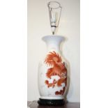 A large reproduction Chinese style table lamp, on a white ground decorated with dragons amidst