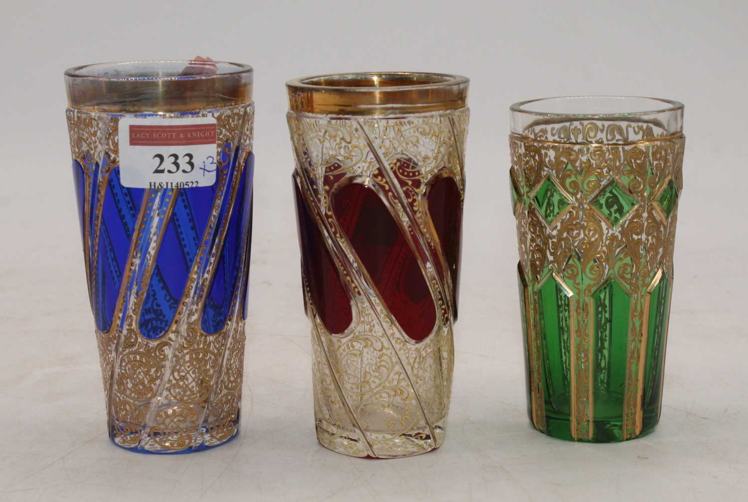 A matched set of three 19th century Bohemian overlaid glass beakers, the largest height 12.5cm