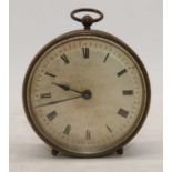 An early 20th century brass cased travel clock, the painted dial showing Roman numerals, height