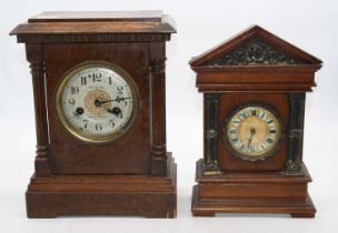 A late 19th century continental oak cased mantel clock, the silvered dial with Arabic numerals and