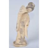 A Japanese Meiji period (1868-1912) ivory okimono, carved as a Geisha girl in standing pose with fan