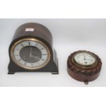 An early 20th century oak cased aneroid barometer the circular silvered dial with Arabic numerals,