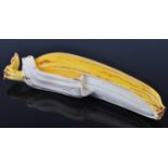 A Japanese Taisho period (1912-1926) stained ivory okimono, carved as a partially peeled banana,