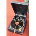 An early 20th century HMV portable wind-up gramophone in rexine covered case with HMV logo,