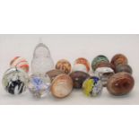A collection of various polished hardstone eggs and glass paperweights