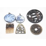 A reproduction iron tsuba, together with a resin carving, pair of blue & white pendants, etc