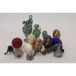 A collection of polished hardstone eggs together with various millefiore paperweights and jugs
