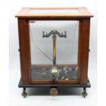 A mid-20th century teak cased set of laboratory scales, w.44cm