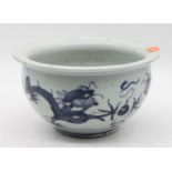 A Chinese stoneware bowl, of squat circular form, underglaze blue decorated with two dragons chasing