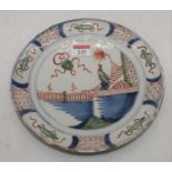 An 18th century Dutch Delft plate, decorated with an eastern figure within a landscape (a/f), dia.