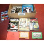 A box of books and magazines relating to motorsports