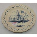 An 18th century creamware plate decoration with a pagoda within a landscape (a/f), dia. 24cm Has