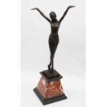 After Chiparus - an Art Deco style bronzed figure of a female dancer, in standing pose with