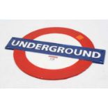 A reproduction painted metal London Underground sign, w.30cm