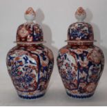 A pair of Japanese imari porcelain urns, each decorated with birds amongst flowers, h.37cm