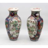 A pair of Japanese export vases, of baluster form, each having opposing reserves enamel decorated