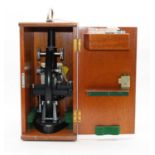 A 20th century student's monocular microscope, in fitted teak case, h.36cm