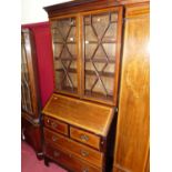 An Edwardian mahogany and satinwood inlaid bureau bookcase, having twin astragal glazed upper