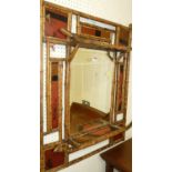 An early 20th century Japanese bamboo and red lacquer panelled inset mirrored two-tier wall shelf,