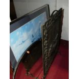An embossed brass fire screen, a beveled oval wall mirror, one other mirror, and an aircraft