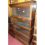A 1920s oak Globe Wernicke four-tier stacking bookcase, having typical hinge glazed doors, with