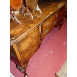 An early 20th century figured walnut sideboard, raised on shell capped cabriole supports, width