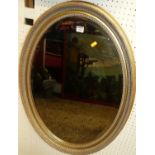 A contemporary gilt framed oval bevelled wall mirror, 80 x 60cmSome small areas of wear to gilt,