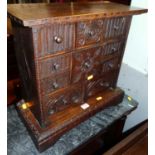 A small relief carved oak table top chest of ten various drawers, width 45cm