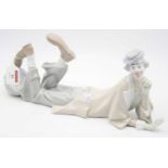 A large Lladro Spanish porcelain figure of a clown in reclining pose with a ball at his feet, having