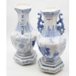 A pair of modern blue & white vases on stands, each of hexagonal baluster form with shaped twin