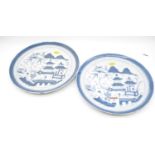 A pair of stoneware plates each of circular form underglazed blue decorated in the Chinese style