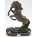 A reproduction bronzed figure of a rearing horse on naturalistic base and oval plinth, height 33cm