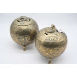 A pair of eastern brass pot pourri, each of squat circular form, the covers decorated with kylin,