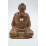 A carved hardwood figure of a deity in typical seated lotus pose, height 32cm