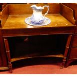 An early 19th century mahogany three-quarter backed washstand, raised on ring turned supports united