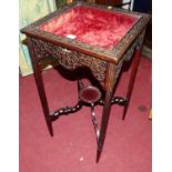 An Edwardian mahogany relief decorated square hinged glazed top bijouterie table, with plush