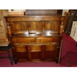 A contemporary oak court cupboard, with floral and linenfold decoration, width 140cm